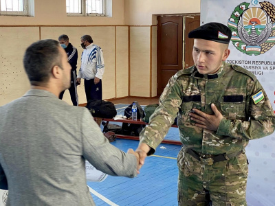 Participants of the Uzbekistan Mas-Wrestling Championship greet friends around the world